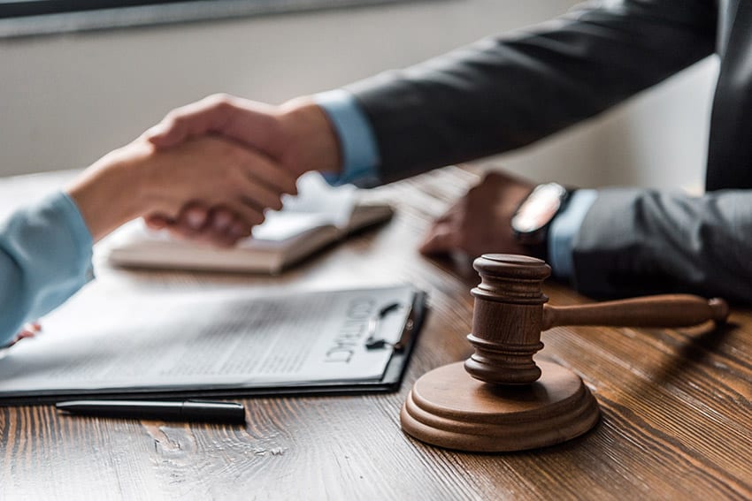 photo of a civil litigation lawyer shaking hands with his client after successfully litigating and winning a case, a service and result you can work to achieve with the help and experience of Safi Law Group, experienced in civil litigation and motor vehicle accident claims