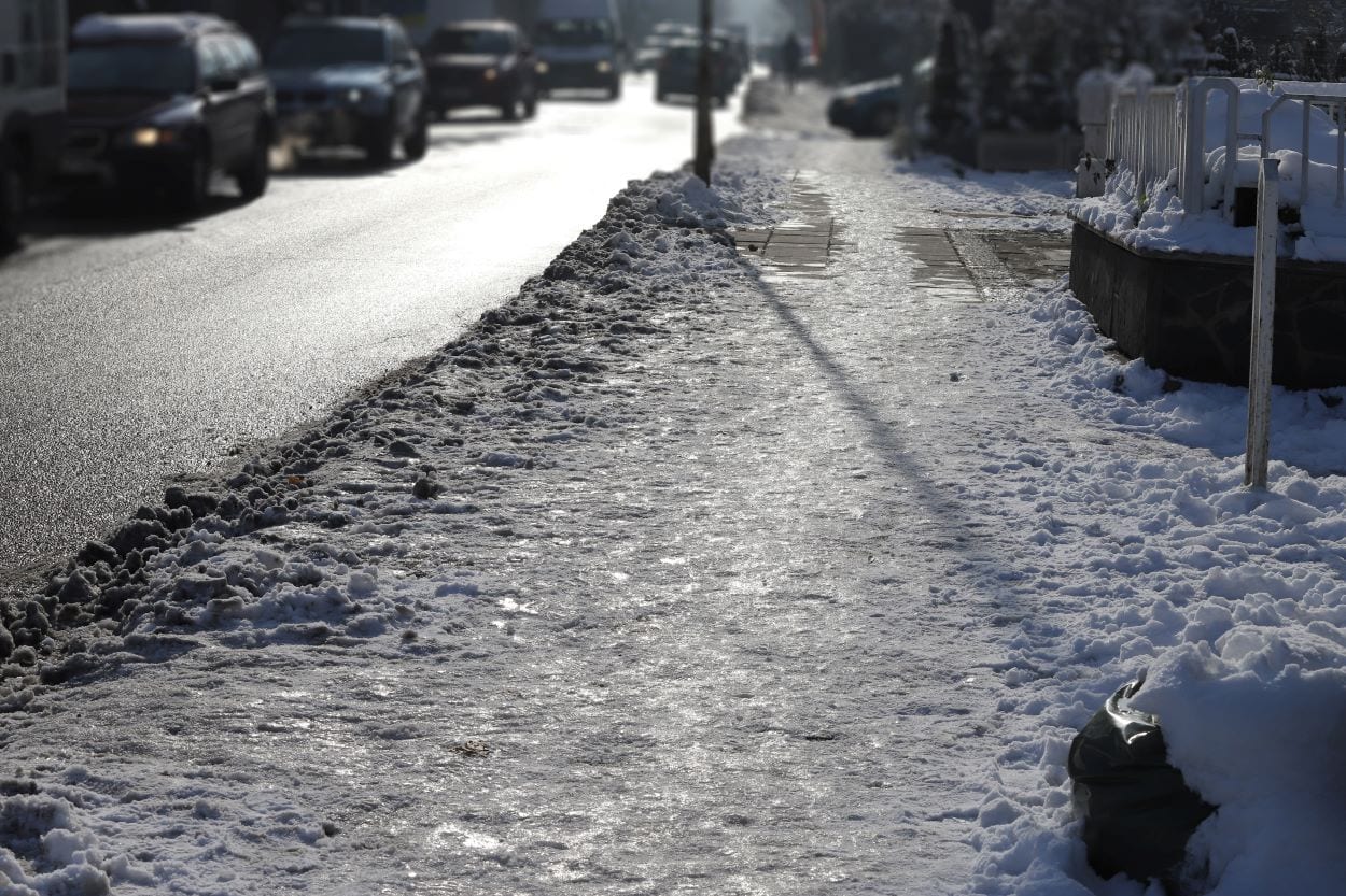 photo of a slippery Edmonton sidewalk, not cleared of snow and ice, an unfortunate slip and fall accident waiting to happen